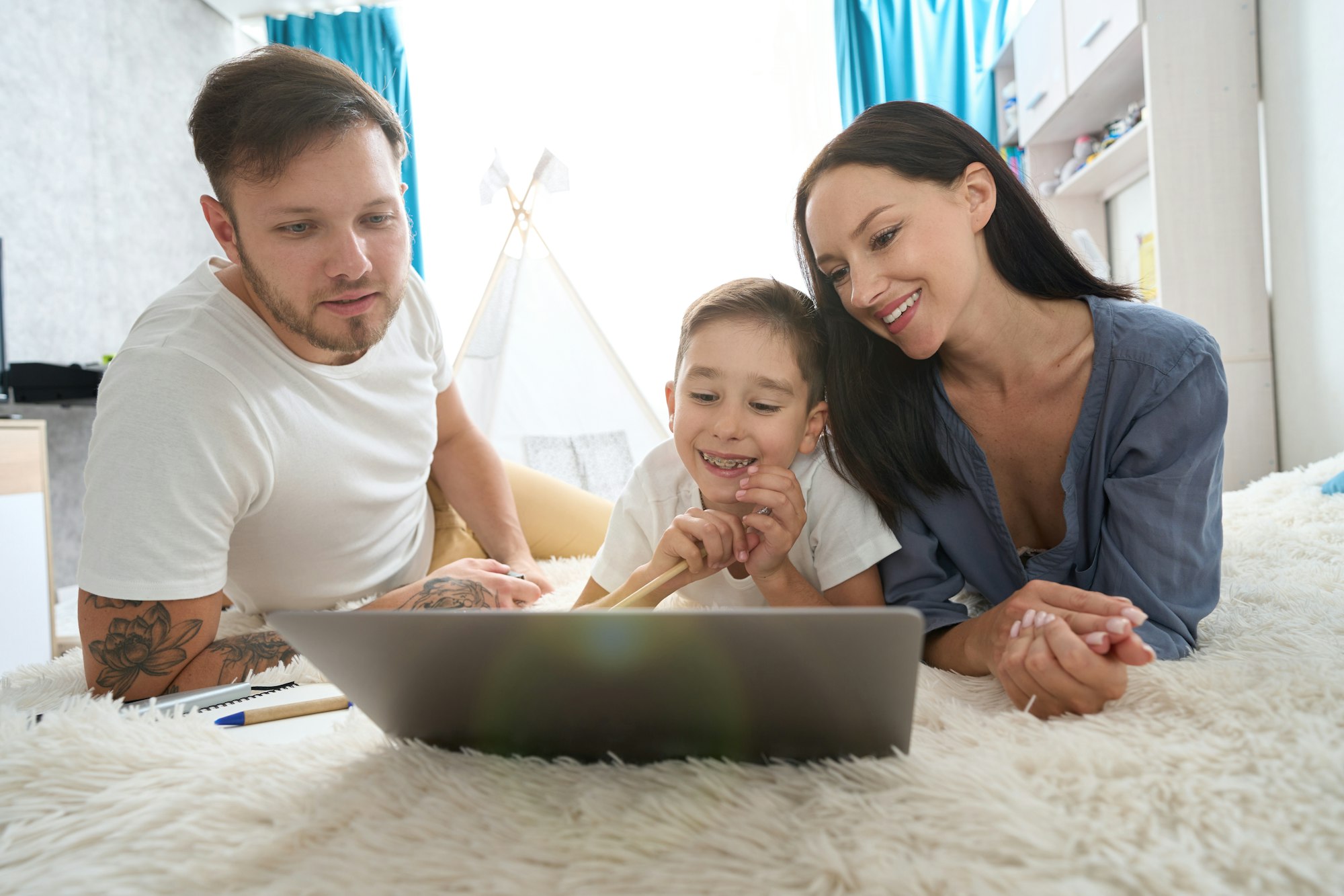 Teenager boy sorting out homework with parental support